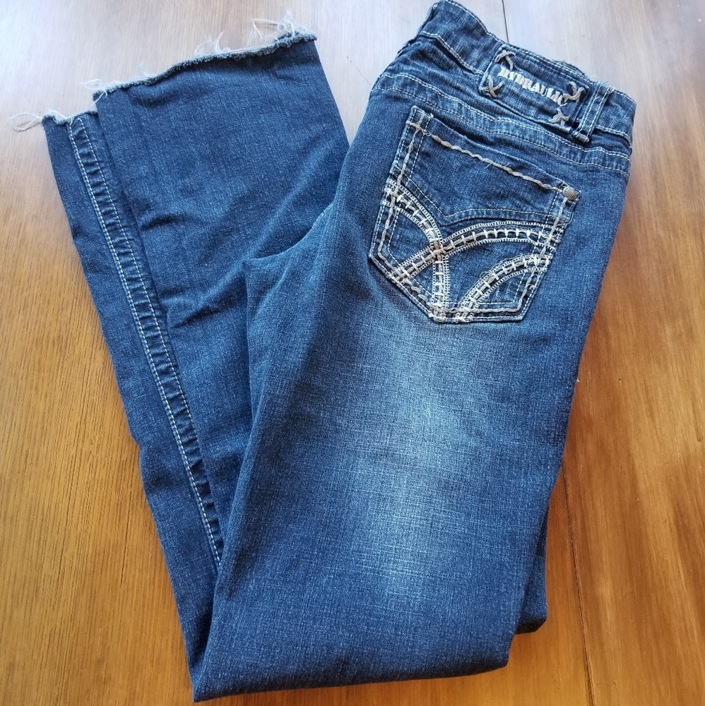 Hydraulic raw edge almost boot distressed jean